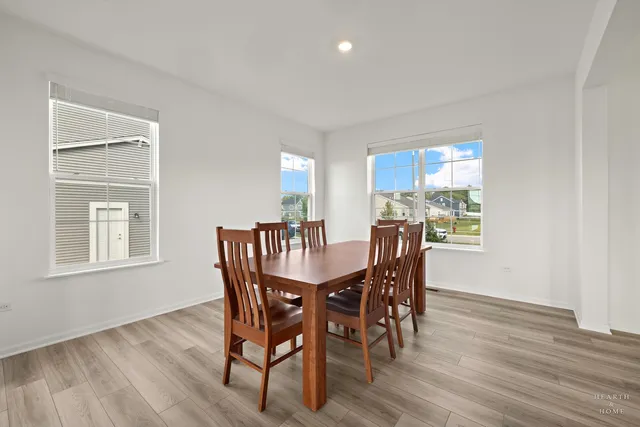a view of a dining room with furniture and wooden floor