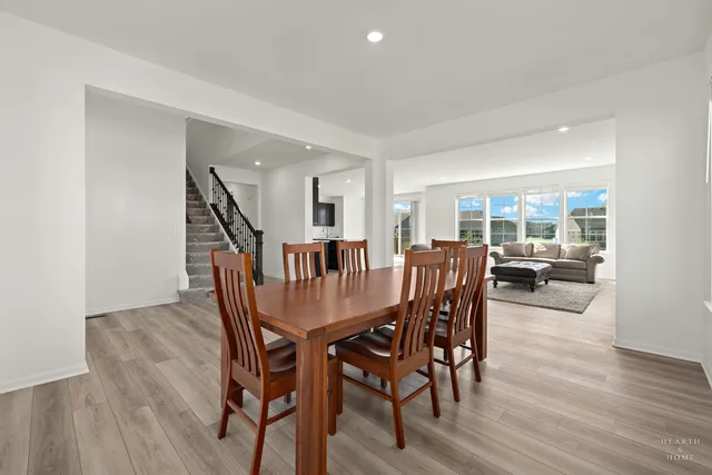a dining room with furniture window and wooden floor