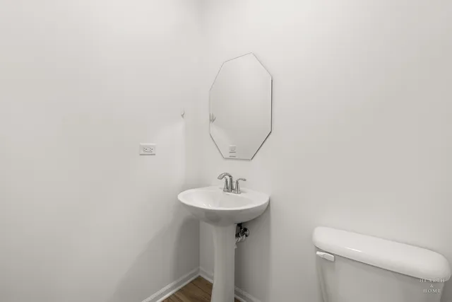 a bathroom with a sink a mirror and a toilet
