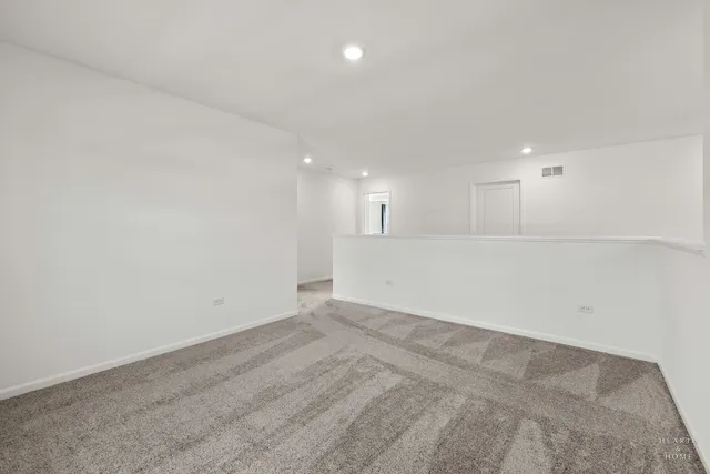 an empty room with a kitchen