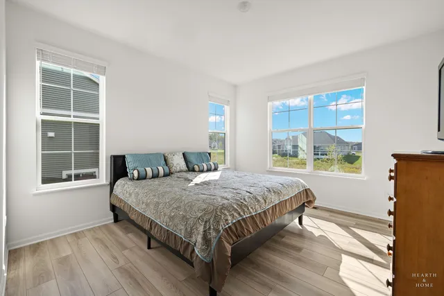 an entryway of a house with wooden floor and stairs