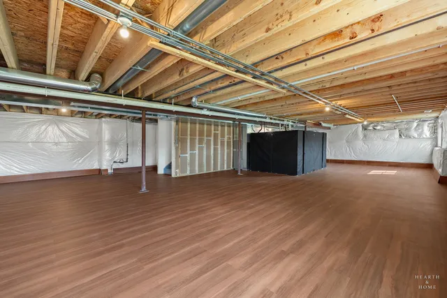 a view of a room with wooden floors and stairs