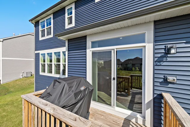 an aerial view of ocean and residential houses with outdoor space