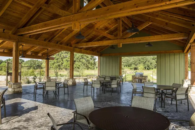 a view of a swimming pool with an outdoor seating