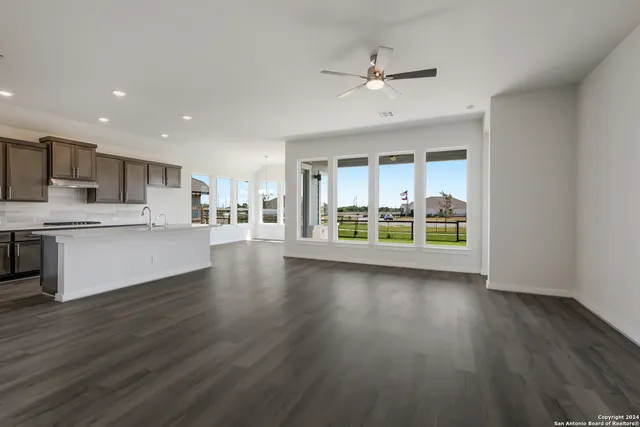 a view of a kitchen with wooden floor and a window