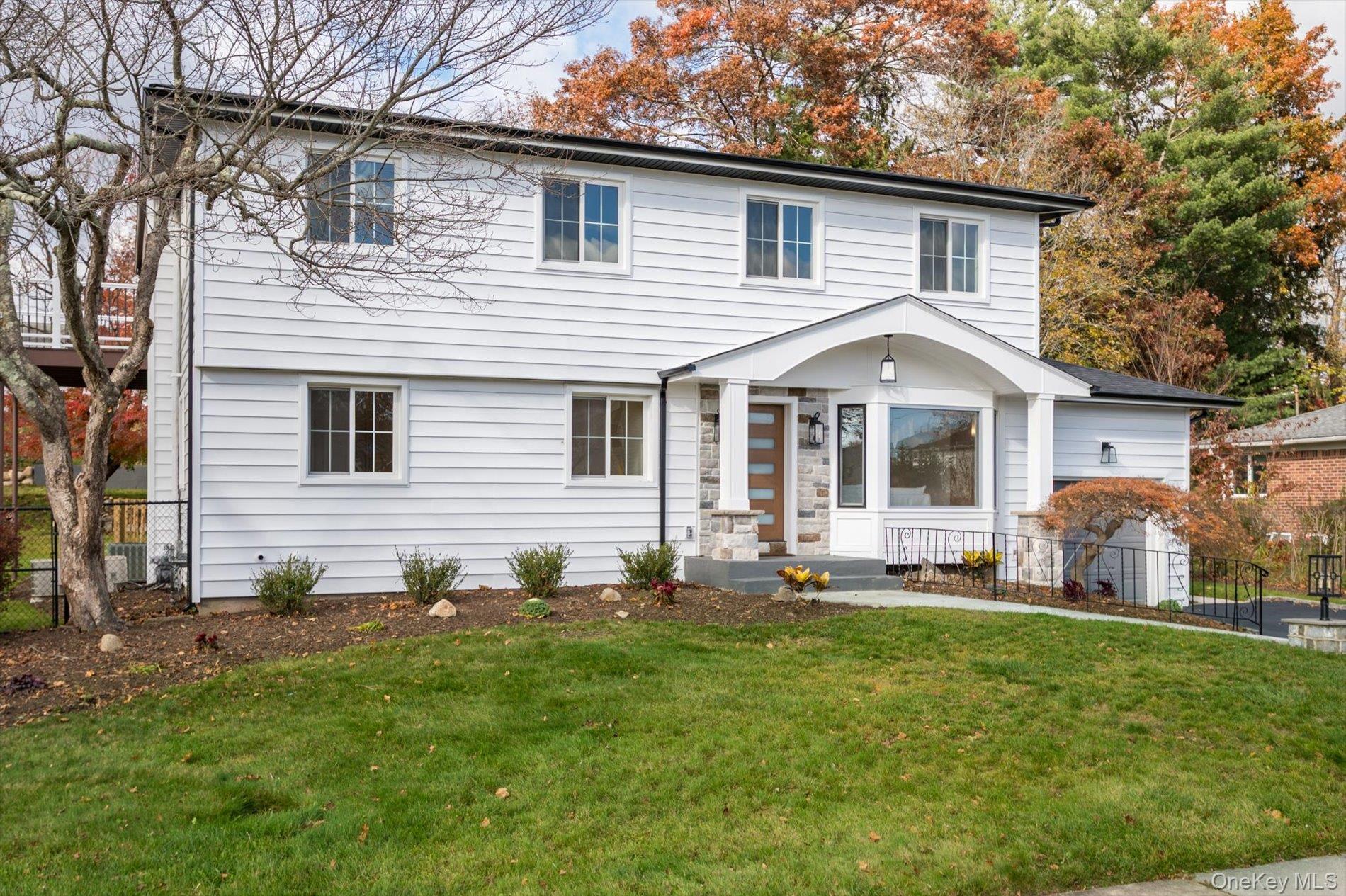 a front view of a house with a garden and yard