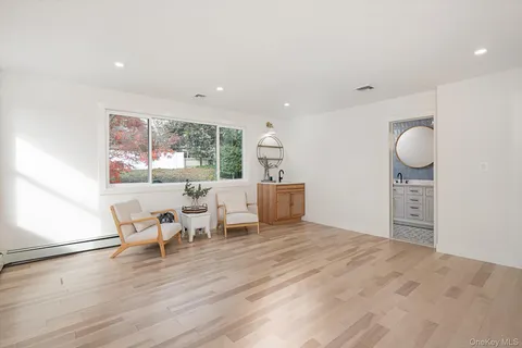 a view of a work space with wooden floor and windows