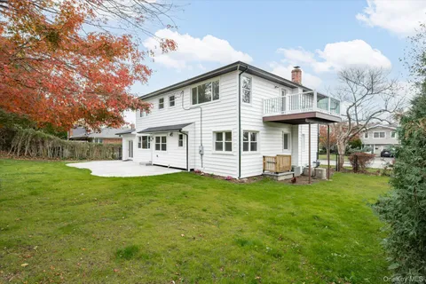 a view of a house with a yard and sitting area