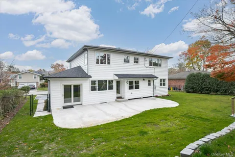 a view of a house with a yard porch and sitting area