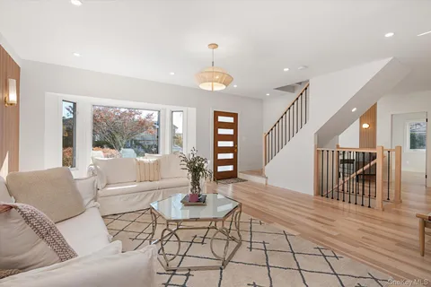 a living room with furniture dining table and a large window