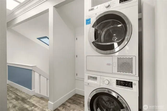 a bedroom with a large bed chandelier and a window