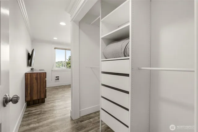 a bedroom with a large bed and a window