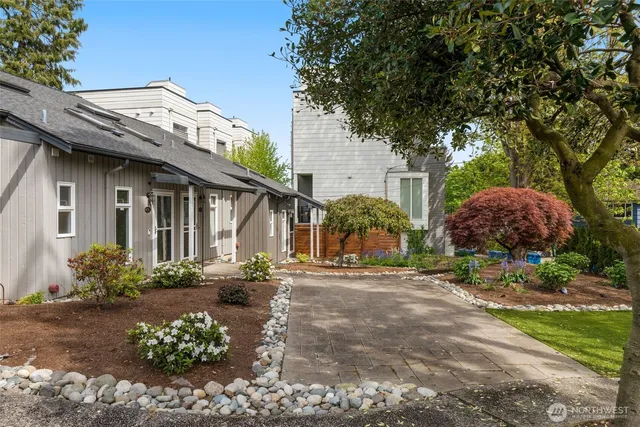 a front view of a house with a garden