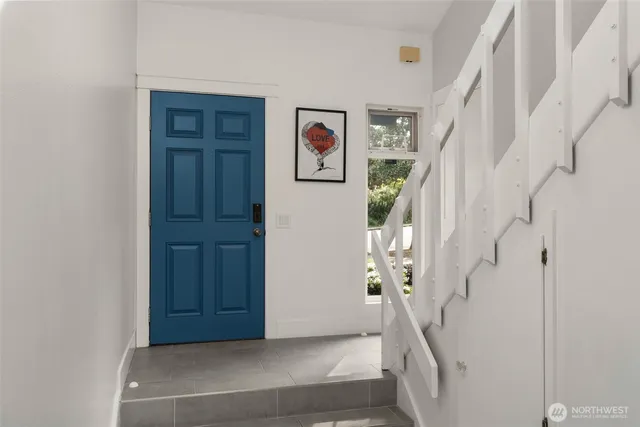 a view of entryway and hall with wooden floor