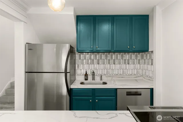 a white refrigerator freezer sitting inside of a kitchen