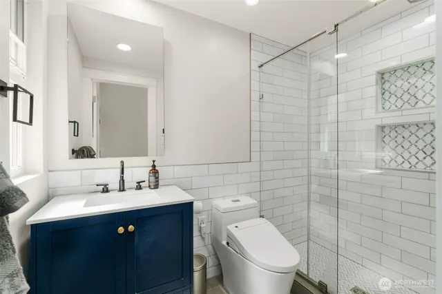 a view of a workspace with furniture and a ceiling fan