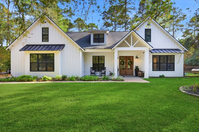 a front view of a house with a yard and porch