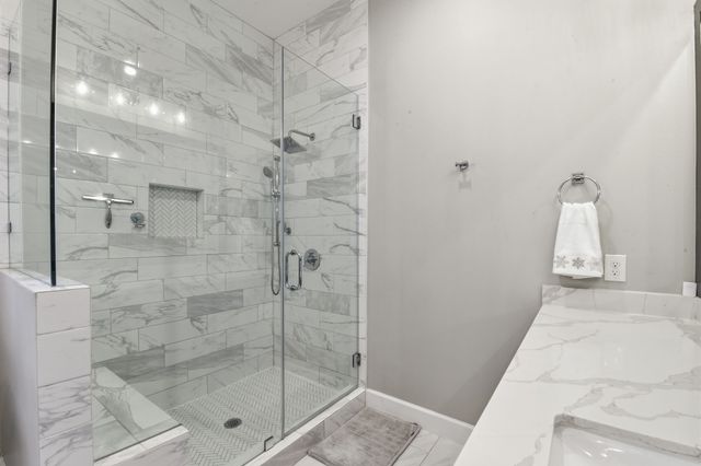 a spacious bathroom with a granite countertop sink a toilet and mirror