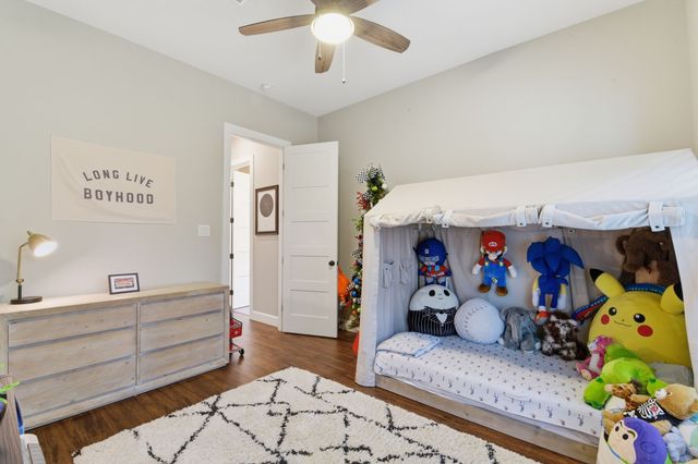 a bed room with a bed mirror and a book shelf