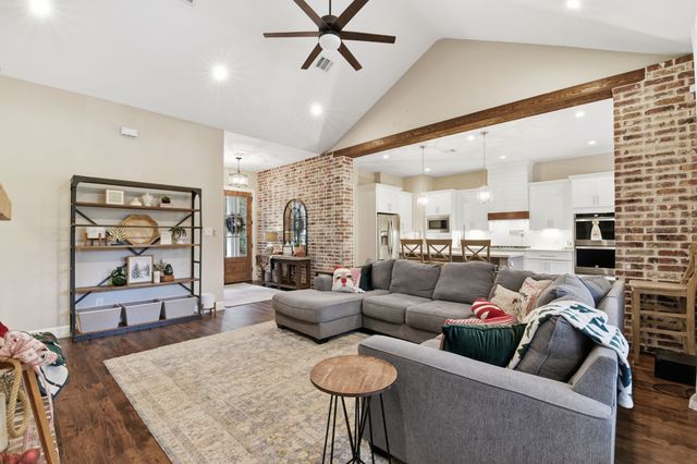 a living room with furniture a rug and a fireplace