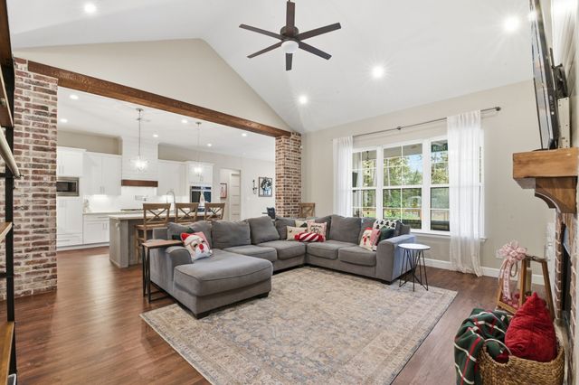 a large kitchen with stainless steel appliances kitchen island a large counter top and a stove top oven