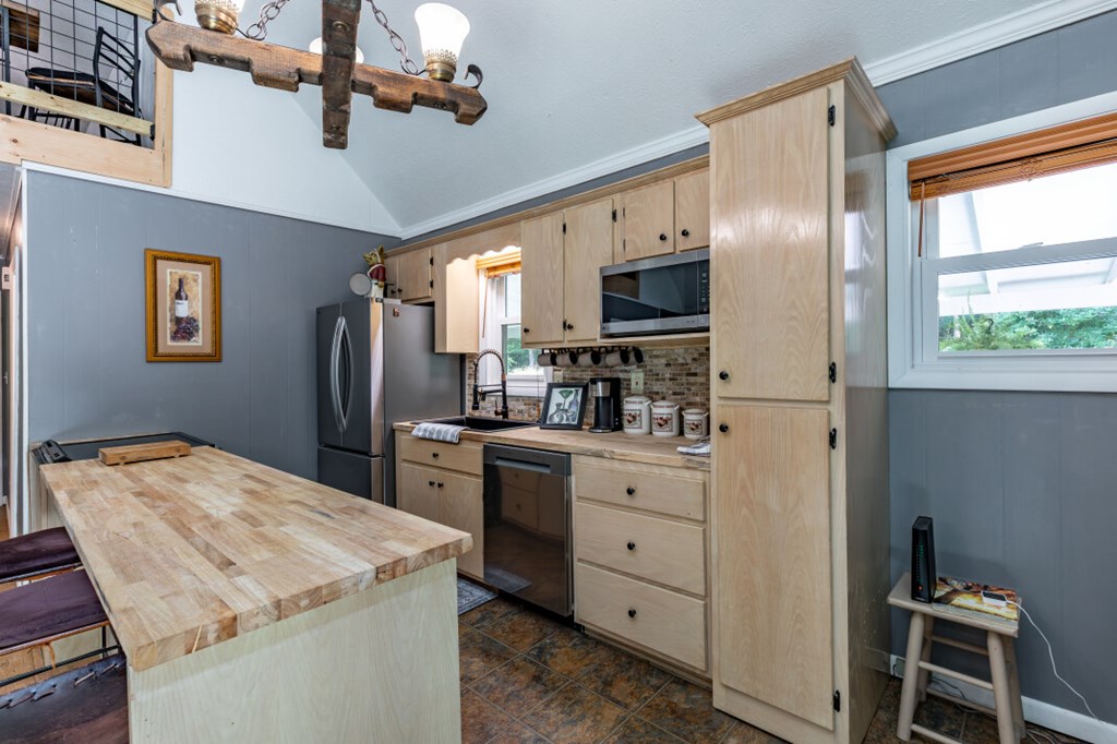 411 Piney Acres Road Blue Ridge, GA 30513 - Photo 16 of 72 a kitchen with refrigerator cabinets and furniture