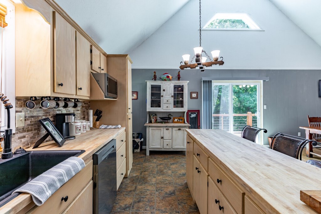411 Piney Acres Road Blue Ridge, GA 30513 - Photo 17 of 72 a kitchen with kitchen island granite countertop a sink stove and cabinets