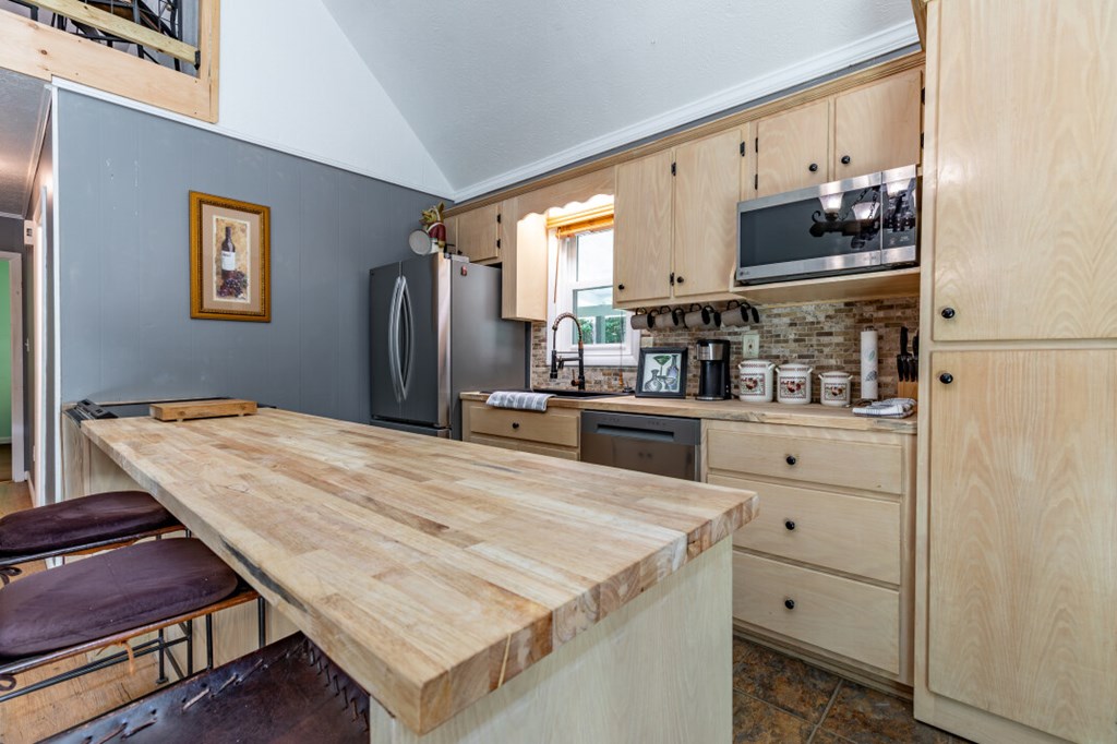 411 Piney Acres Road Blue Ridge, GA 30513 - Photo 19 of 72 a kitchen with stainless steel appliances a stove refrigerator and cabinets