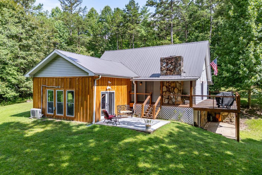 411 Piney Acres Road Blue Ridge, GA 30513 - Photo 2 of 72 a view of a house with a yard patio and chairs