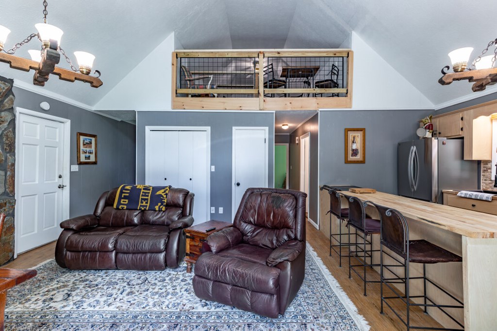 411 Piney Acres Road Blue Ridge, GA 30513 - Photo 21 of 72 a living room with furniture and a chandelier