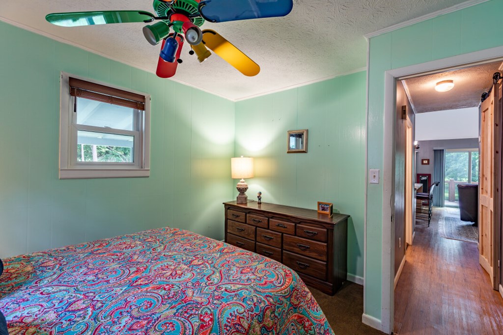 411 Piney Acres Road Blue Ridge, GA 30513 - Photo 30 of 72 a bedroom with a bed and wooden floor