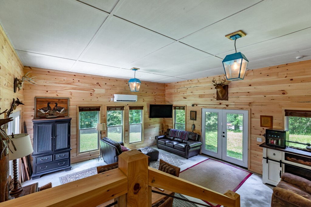 411 Piney Acres Road Blue Ridge, GA 30513 - Photo 46 of 72 a living room with fireplace furniture and a floor to ceiling window