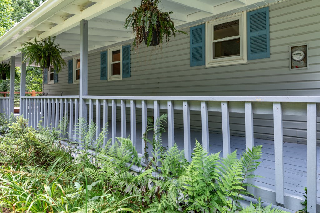411 Piney Acres Road Blue Ridge, GA 30513 - Photo 7 of 72 a view of a house with a small yard and a large window