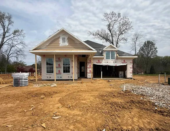 a view of a house with a yard and sitting area