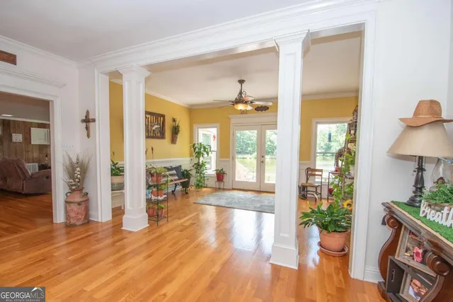 a living room with furniture a flat screen tv and a large window