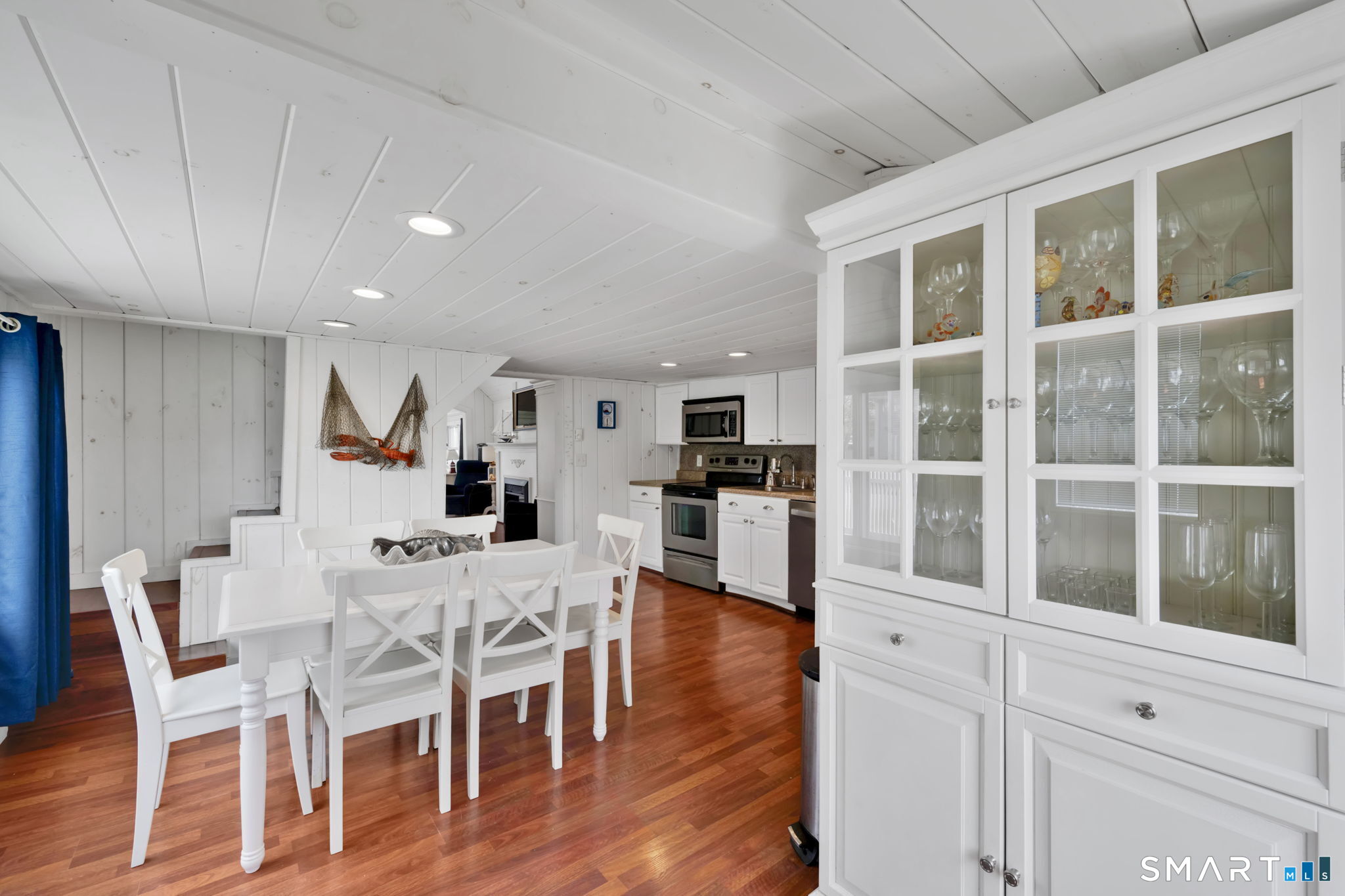 96 Chalker Beach Road Old Saybrook, CT 06475 - Photo 13 of 33 a view of a dining room with furniture a kitchen and wooden floor