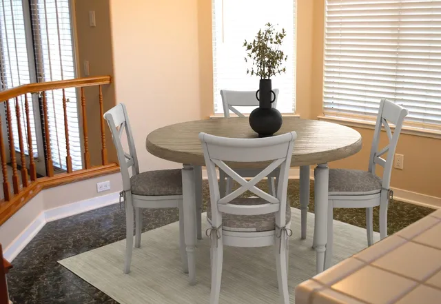 a dining room with furniture and window