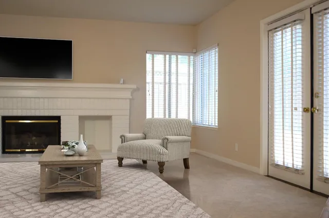 a living room with furniture a fireplace and a flat screen tv