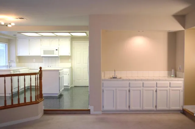 a kitchen with white cabinets