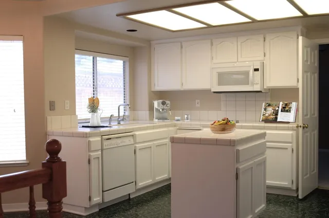 a kitchen with a sink cabinets and window