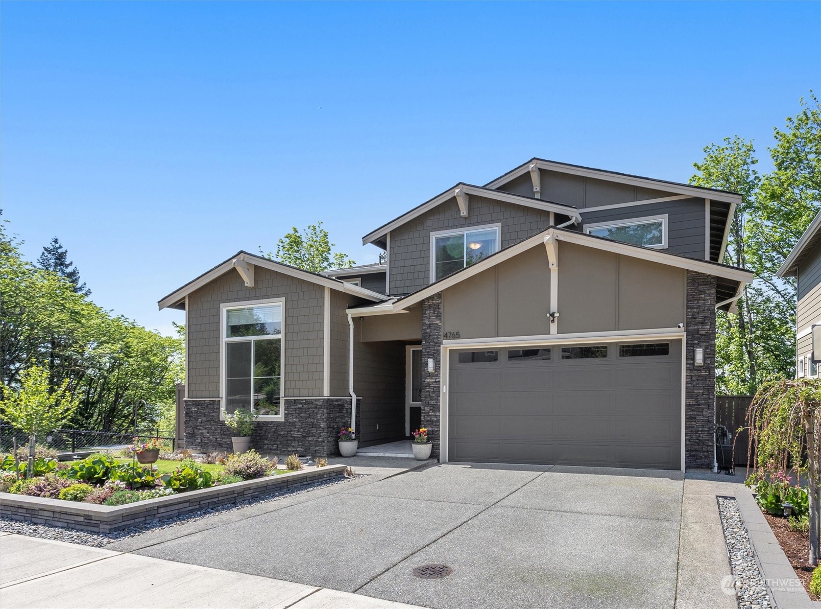 4765 Smithers Avenue South Renton, WA 98055 - Photo 2 of 38 a front view of a house with a garden