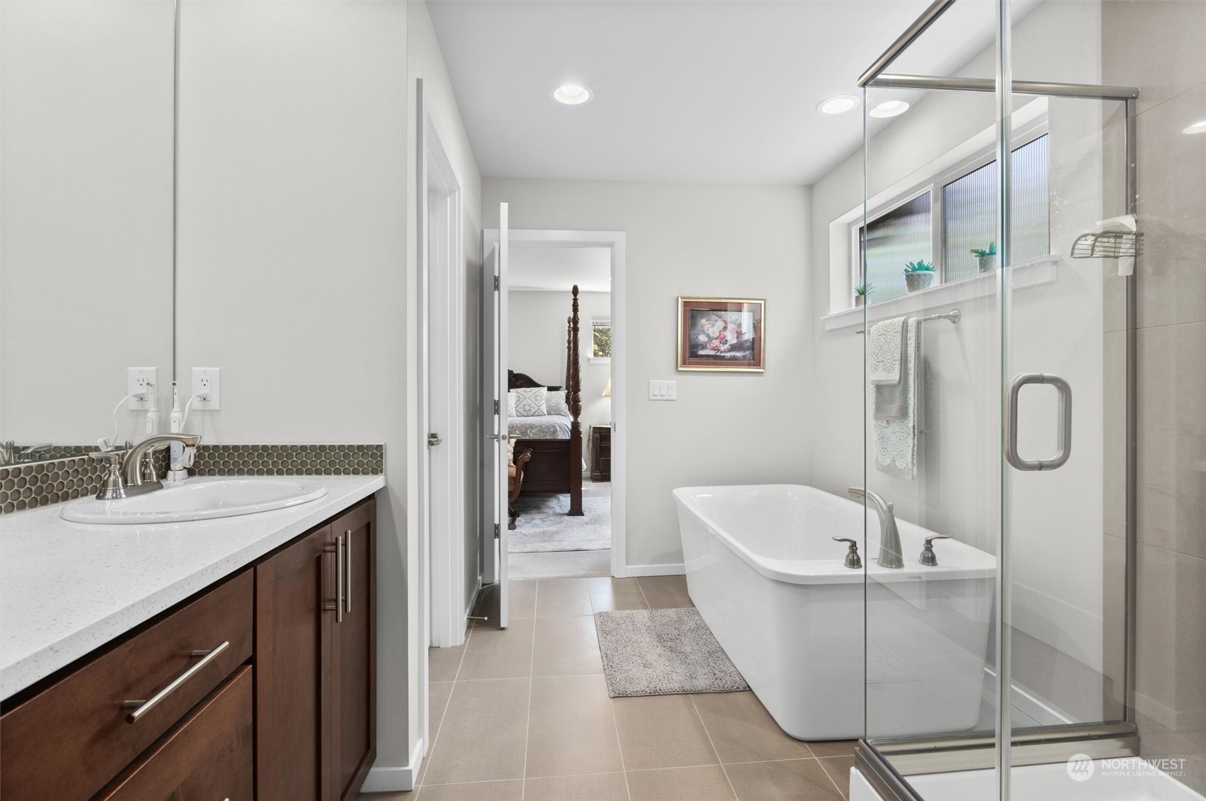 4765 Smithers Avenue South Renton, WA 98055 - Photo 21 of 38 a bathroom with a granite countertop sink a bathtub a shower and a mirror
