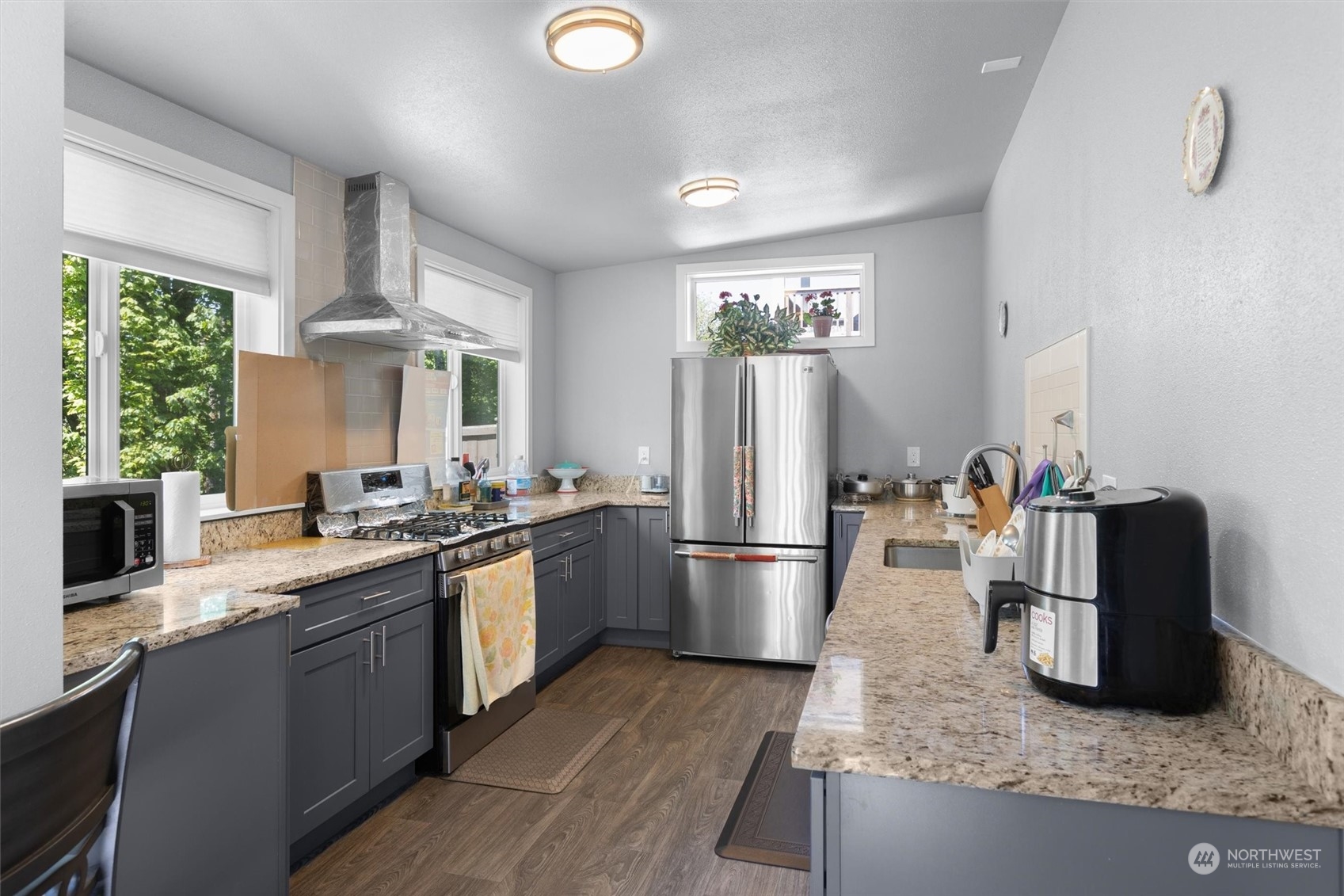 4765 Smithers Avenue South Renton, WA 98055 - Photo 34 of 38 a kitchen with refrigerator and chairs