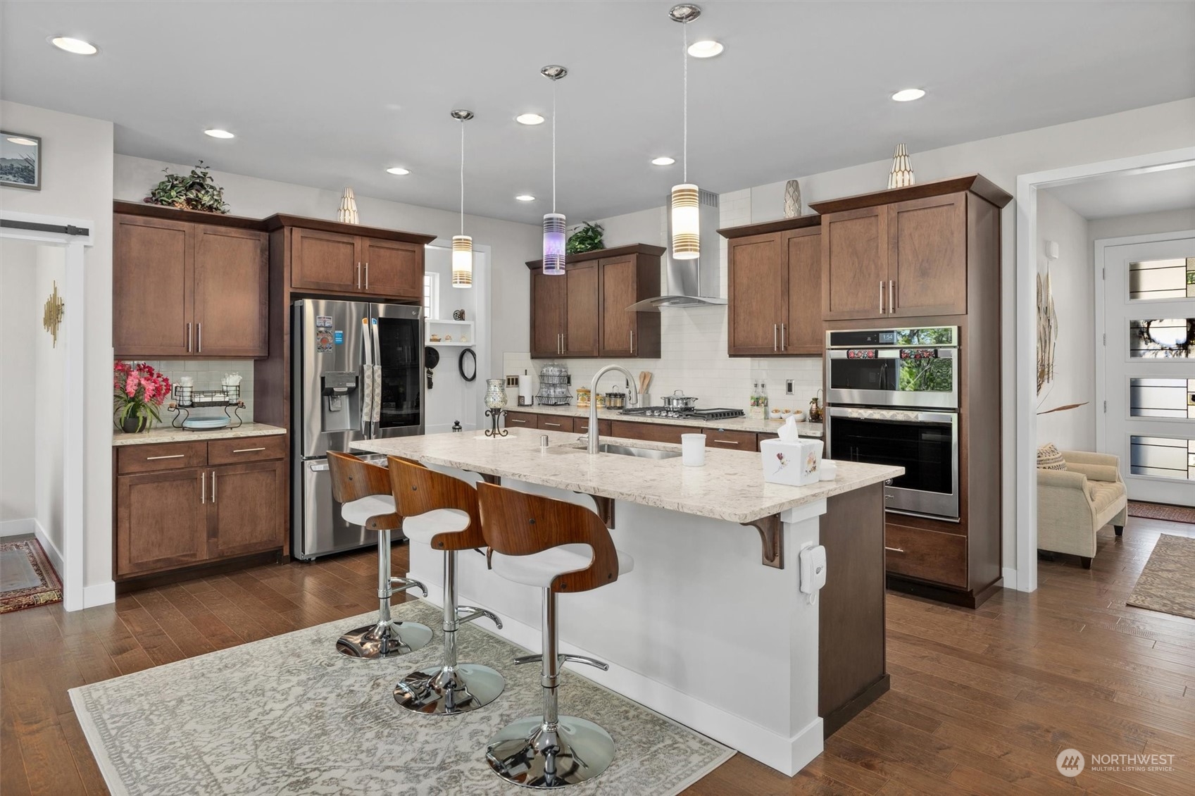 4765 Smithers Avenue South Renton, WA 98055 - Photo 5 of 38 a kitchen with stainless steel appliances kitchen island granite countertop a sink and a refrigerator