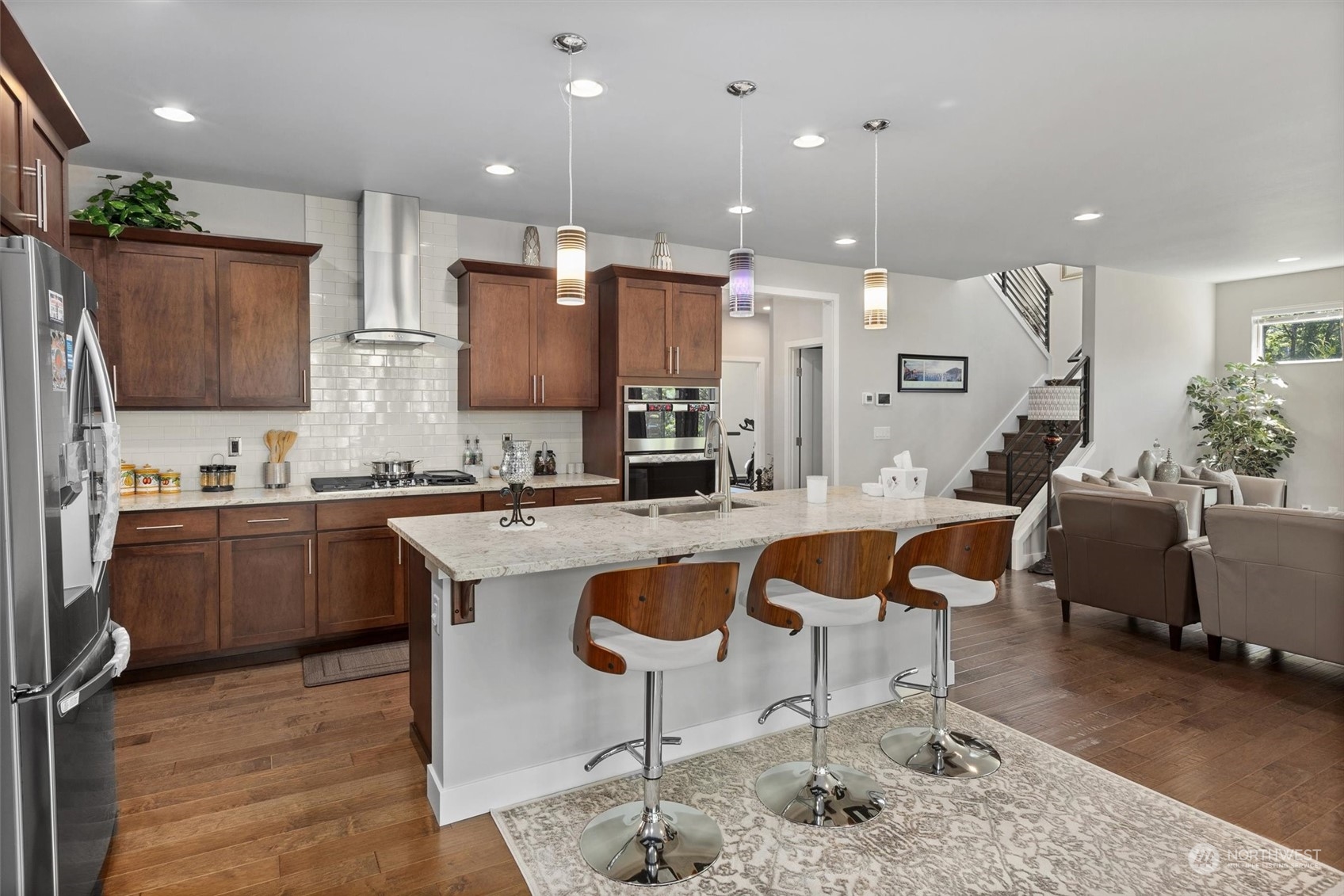 4765 Smithers Avenue South Renton, WA 98055 - Photo 7 of 38 a large kitchen with kitchen island a sink table and chairs