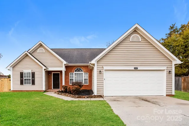 a view of a house with backyard and porch