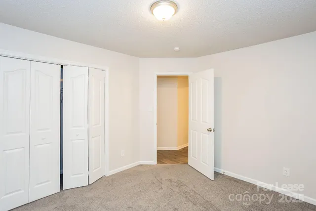 an empty room with closet area