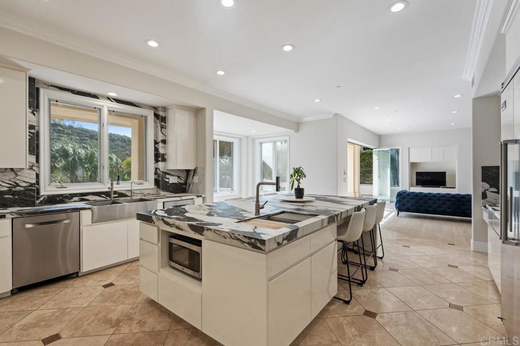 6773 Poco Lago Rancho Santa Fe, CA 92067 - Photo 21 of 65 a kitchen with stainless steel appliances granite countertop a stove and a sink