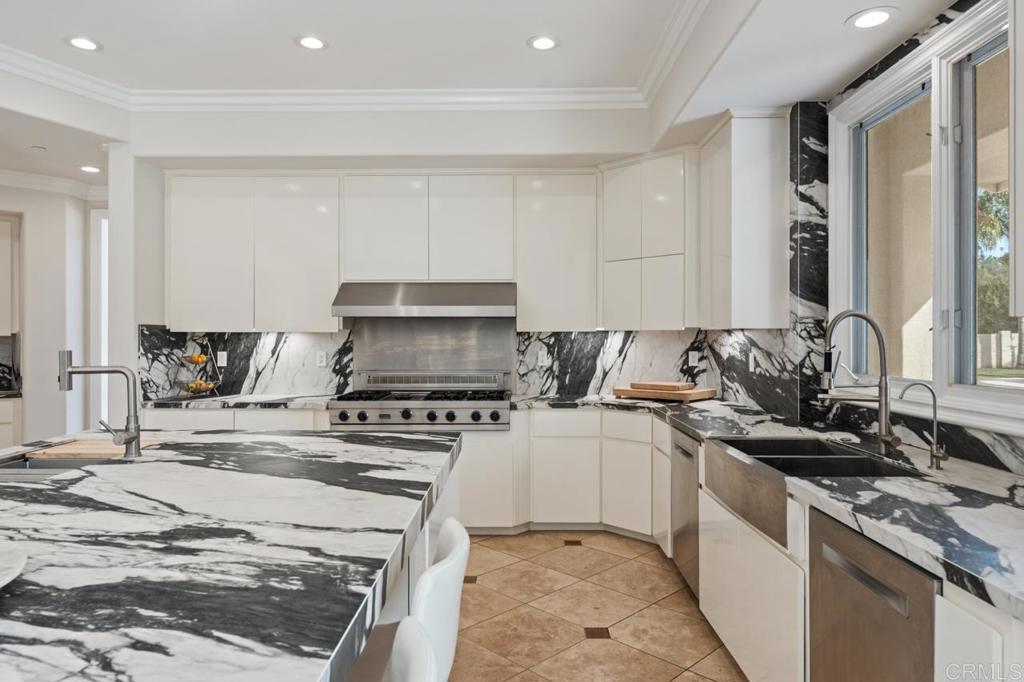 6773 Poco Lago Rancho Santa Fe, CA 92067 - Photo 22 of 65 a kitchen with a stove a sink and a refrigerator