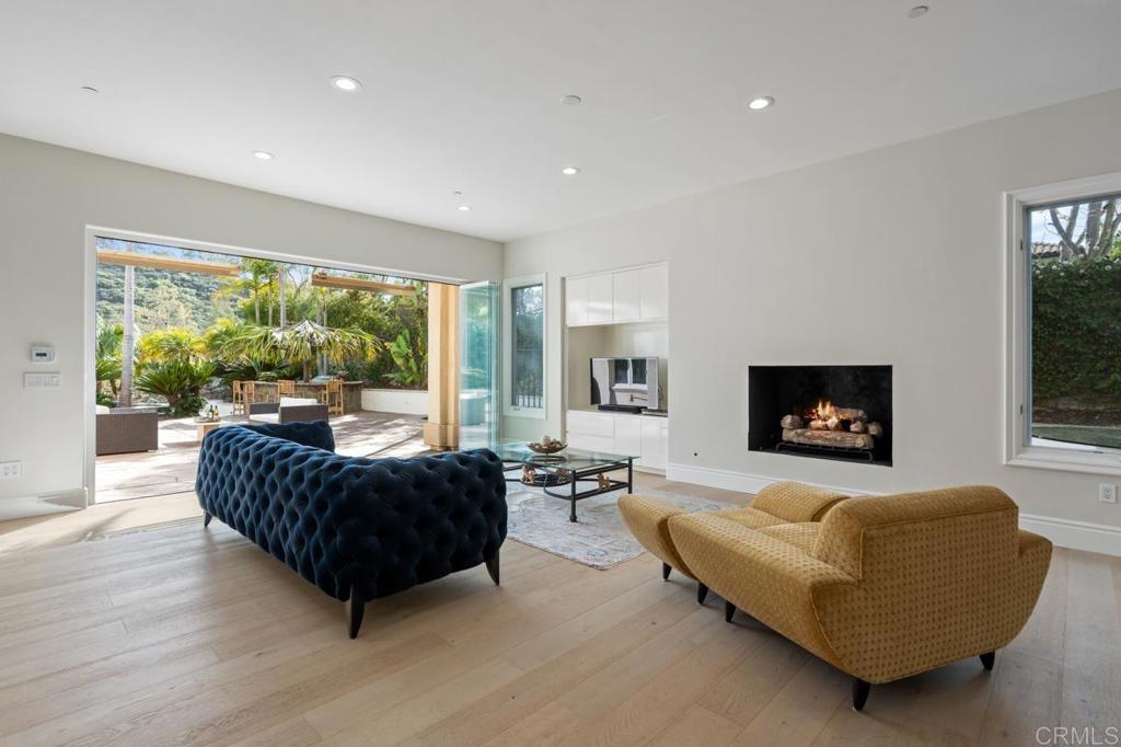6773 Poco Lago Rancho Santa Fe, CA 92067 - Photo 25 of 65 a living room with furniture flat screen tv and a large window